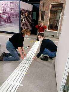 Sticking guiding lines in the new exhibition.