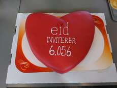 The heart-shaped logo of the community of Eid as cake