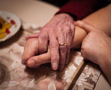 a Caretaker holding the hand of her clinte